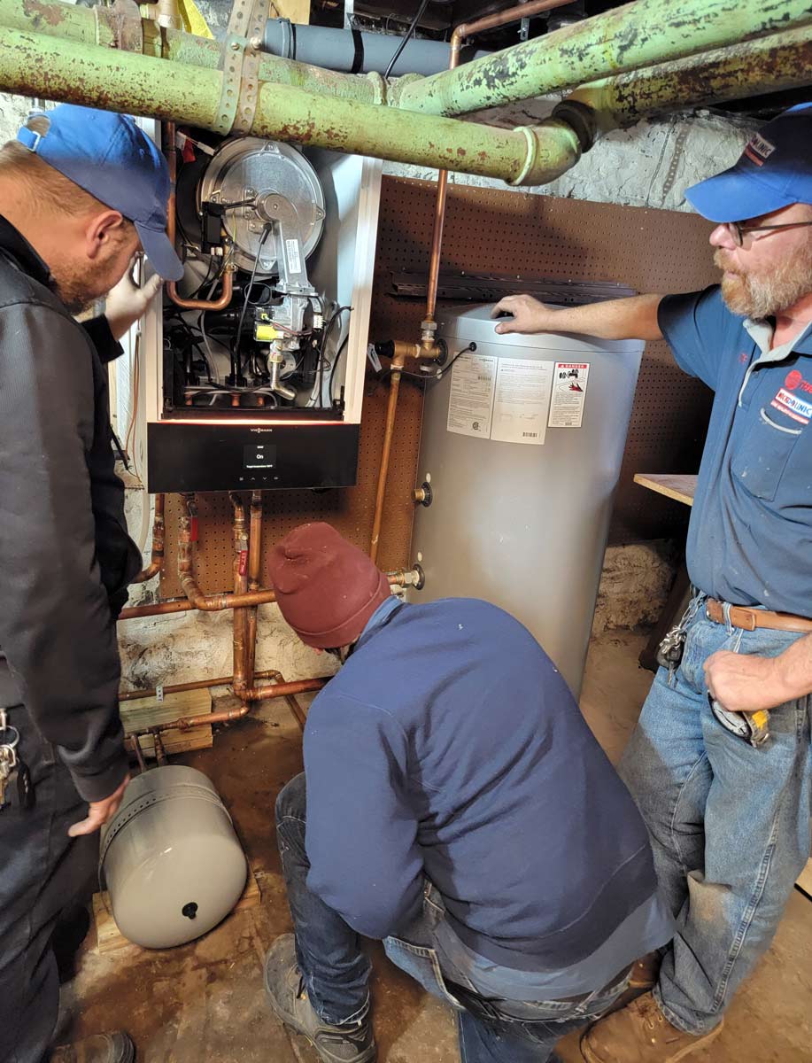 Technician servicing residential boiler equipment