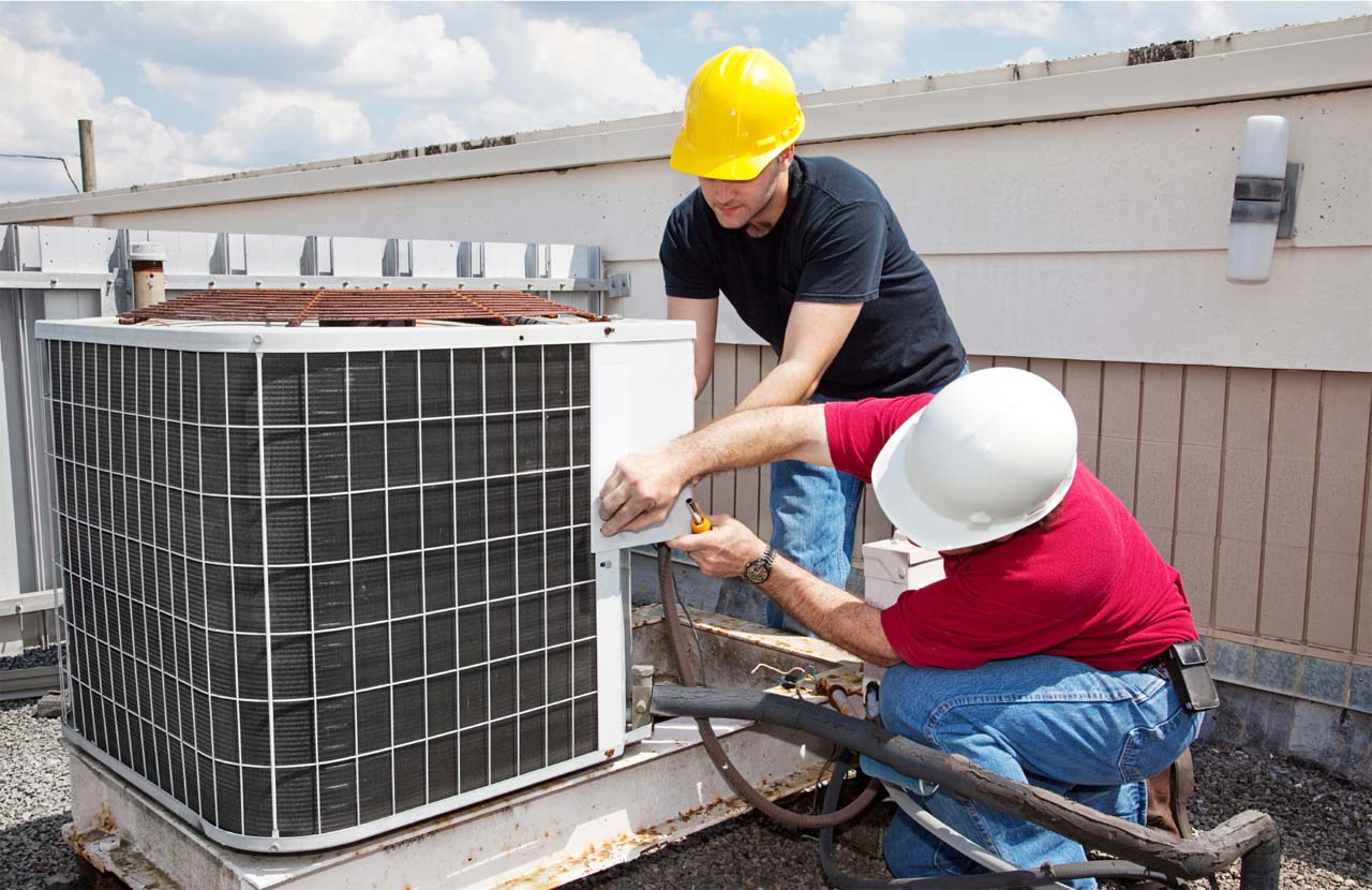 Nick Dolinic technicians servicing an outdoor HVAC unit