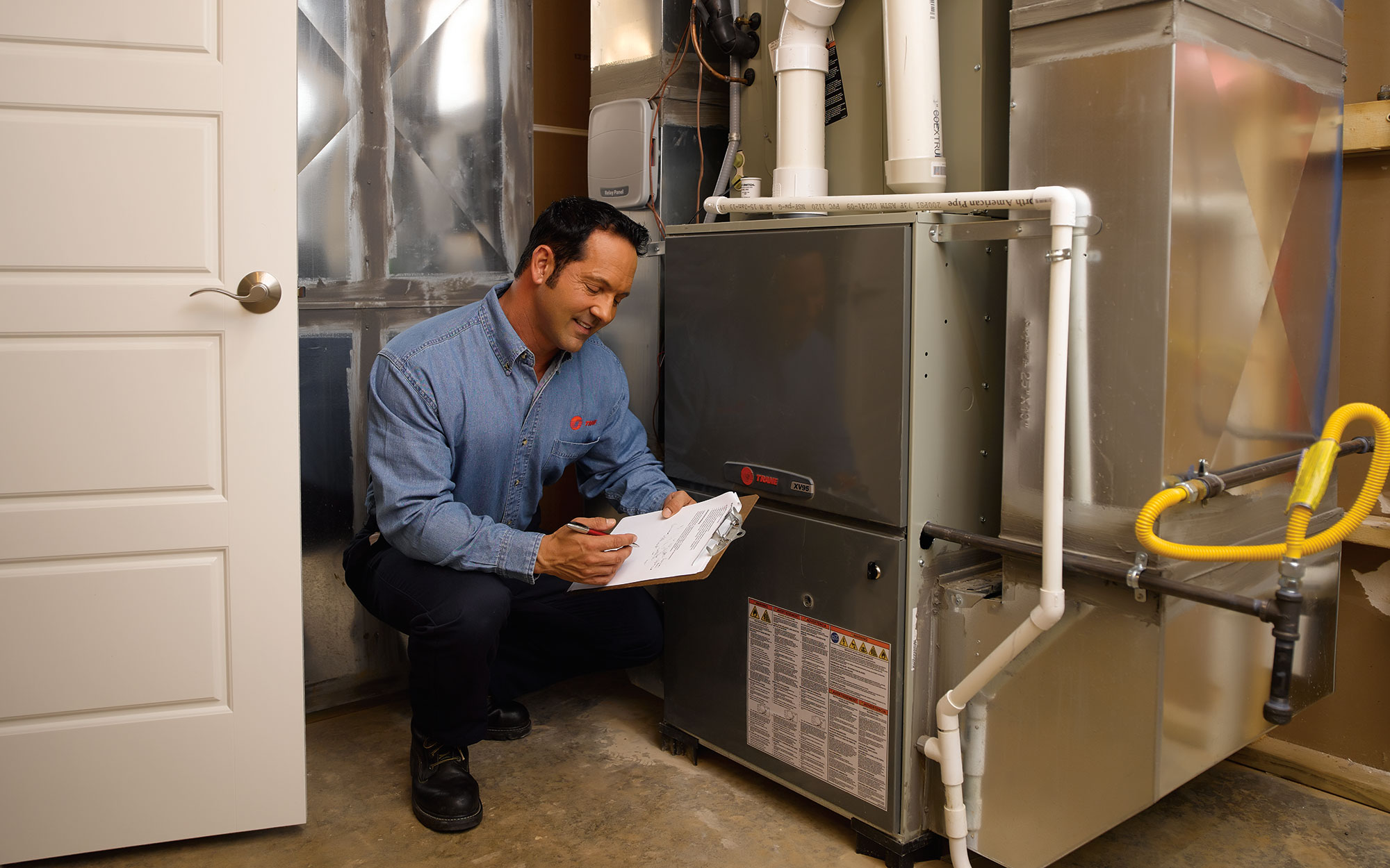Technician diagnosing HVAC equipment